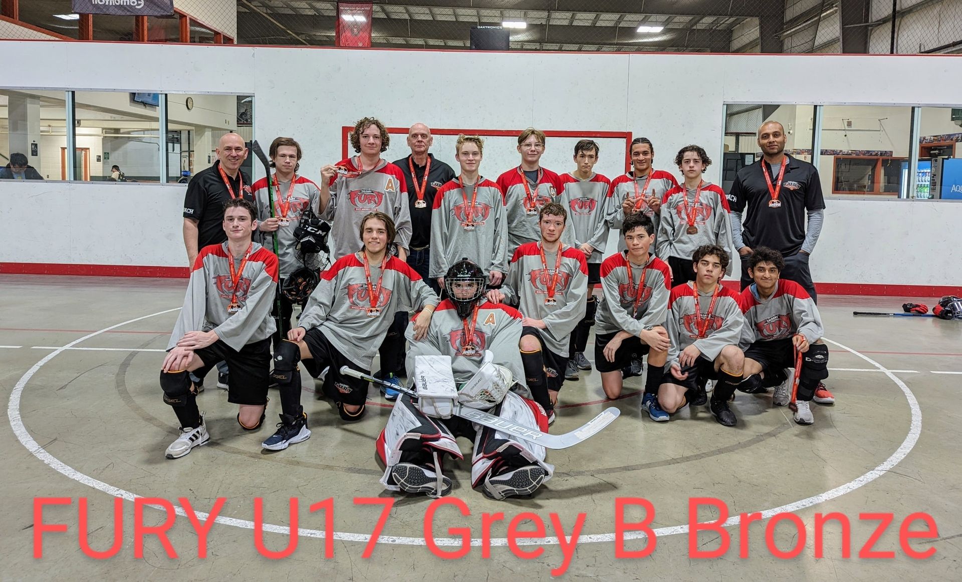 2022 U17 Fury ball hockey team group photo wearing grey jerseys after winning bronze medal