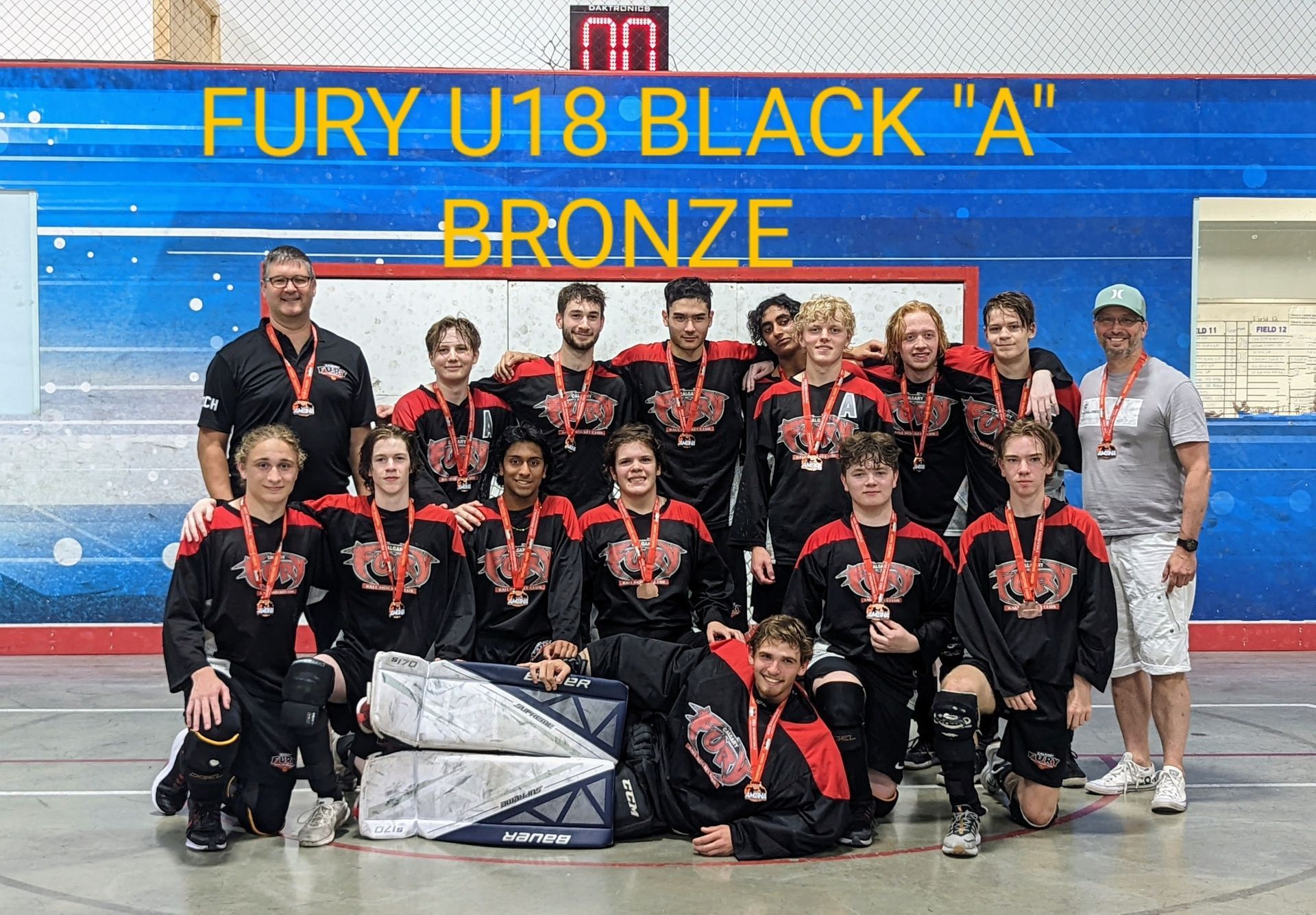 2022 U18 Fury ball hockey team wearing black jerseys after winning bronze