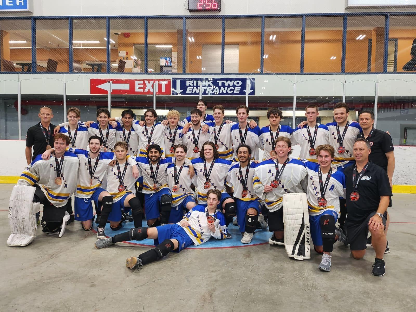 2023 Junior Nationals Team Alberta group photo wearing white jerseys after winning a medal