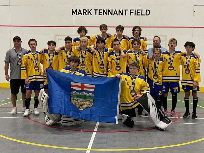 2024 U15 Junior Nationals Team Alberta team group photo wearing yellow jerseys after playing a game