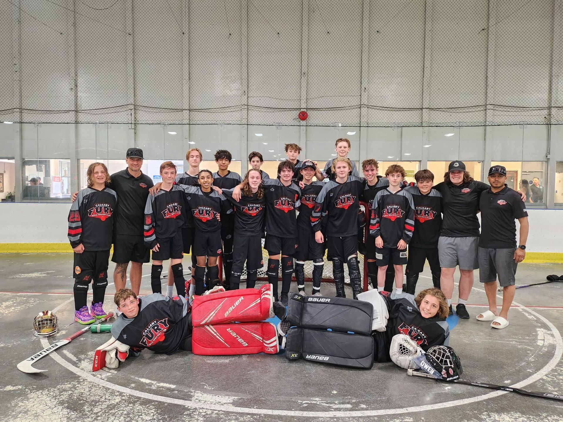 2024 U15 Fury ball hockey team group photo wearing black jerseys after a game at the Western Challenge Cup