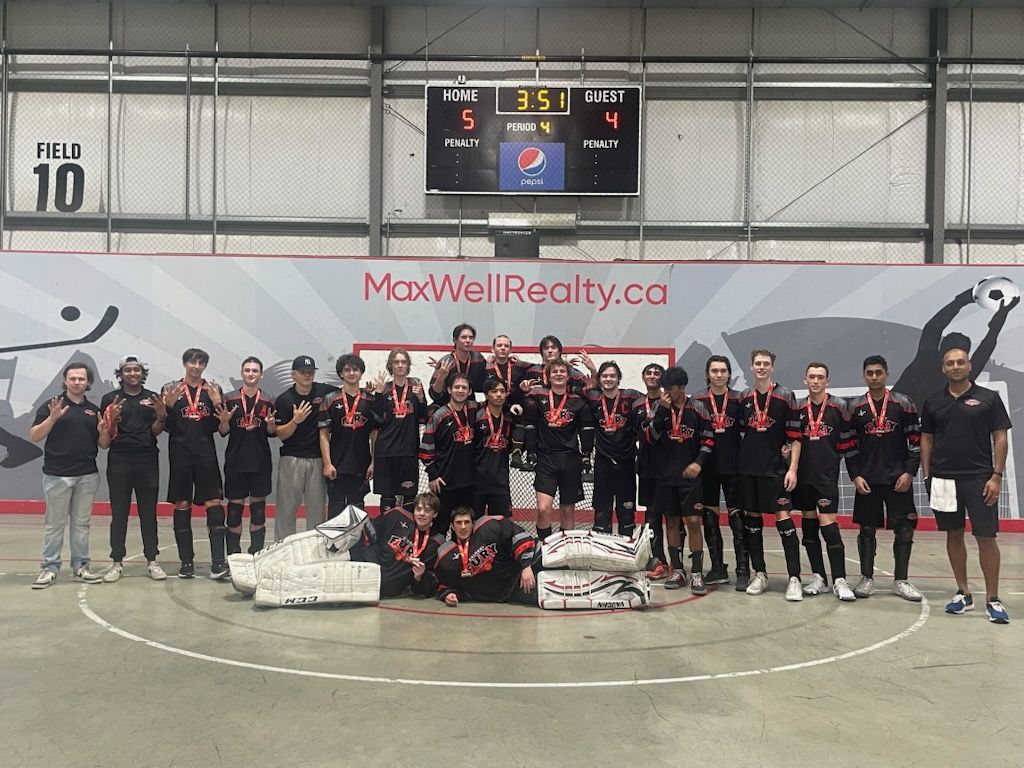 2024 U18 Fury ball hockey team group photo wearing black jerseys after winning a medal