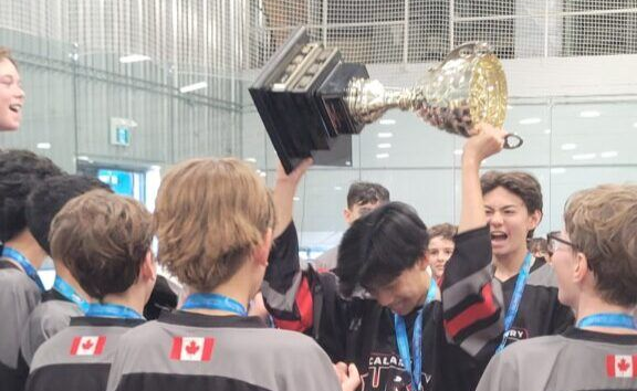 A Fury ball hockey team celebrating while raising the trophy