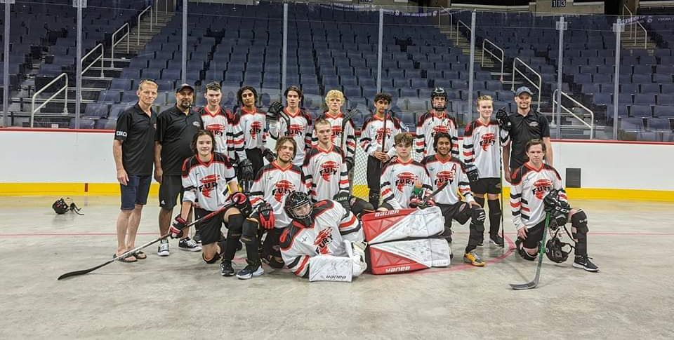 2022 U17 Junior Nationals Fury ball hockey team wearing white jerseys after a game