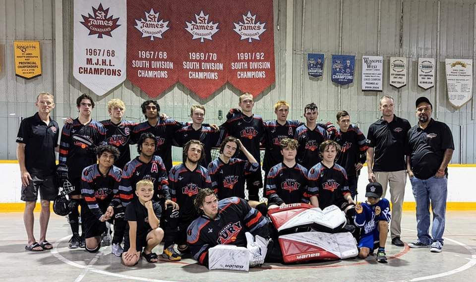 2022 U17 Fury ball hockey team group photo wearing black jerseys after a game