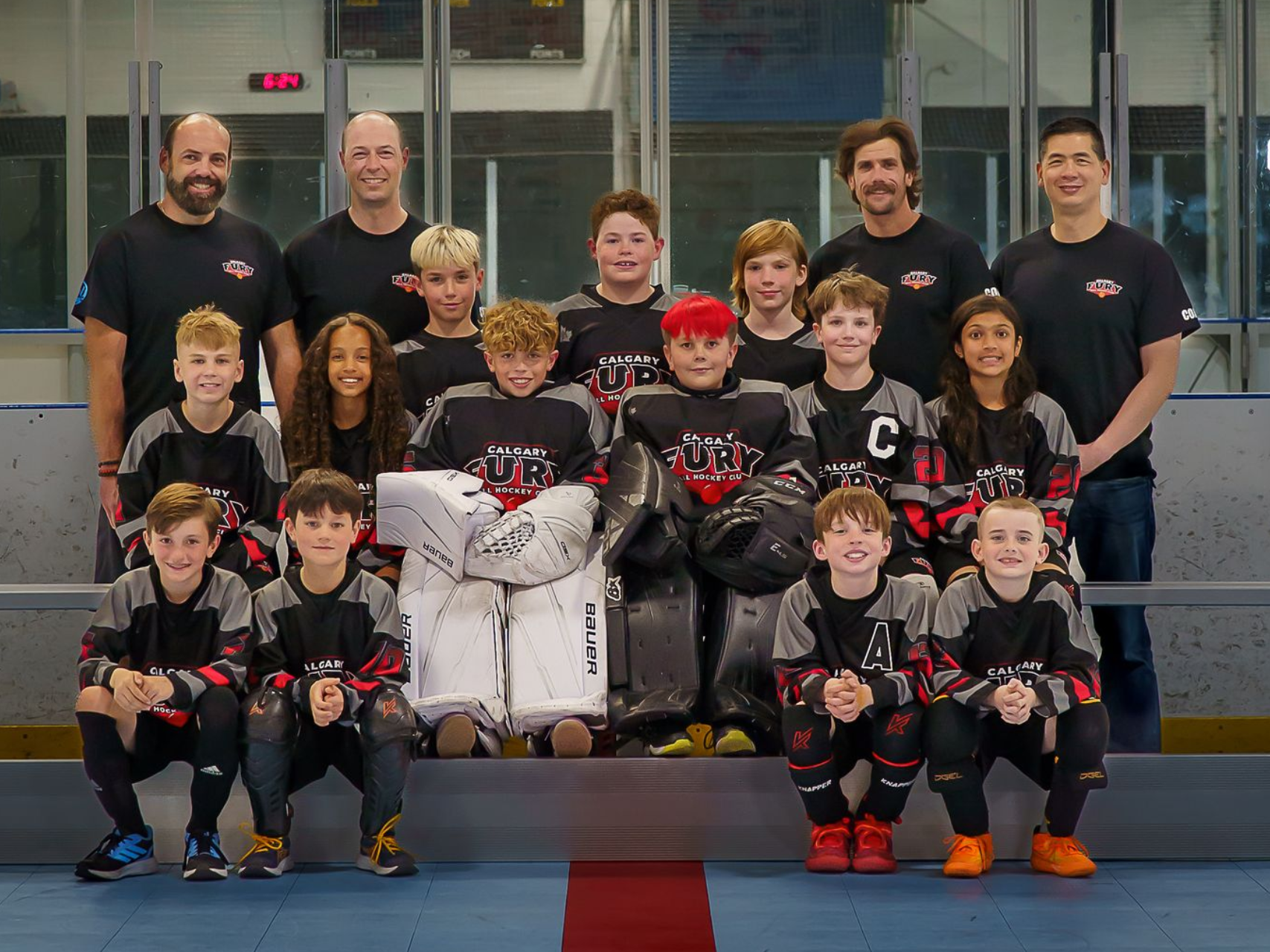 U11B Fury ball hockey team group photo wearing black jerseys