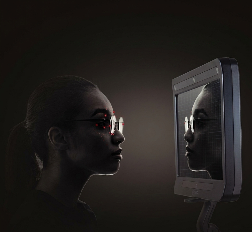 Persona di profilo di fronte a uno schermo luminoso, il cui riflesso è visibile sul display in un ambiente buio.