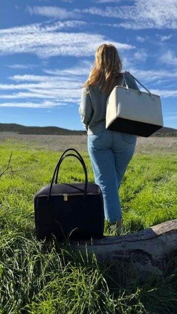 Woman carrying Salt & Stone insulated tote bag by The Stever Co under blue sky