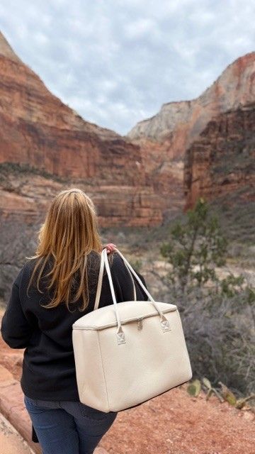 Woman carrying insulated tote bag by The Stever Co with Zion canyon landscape