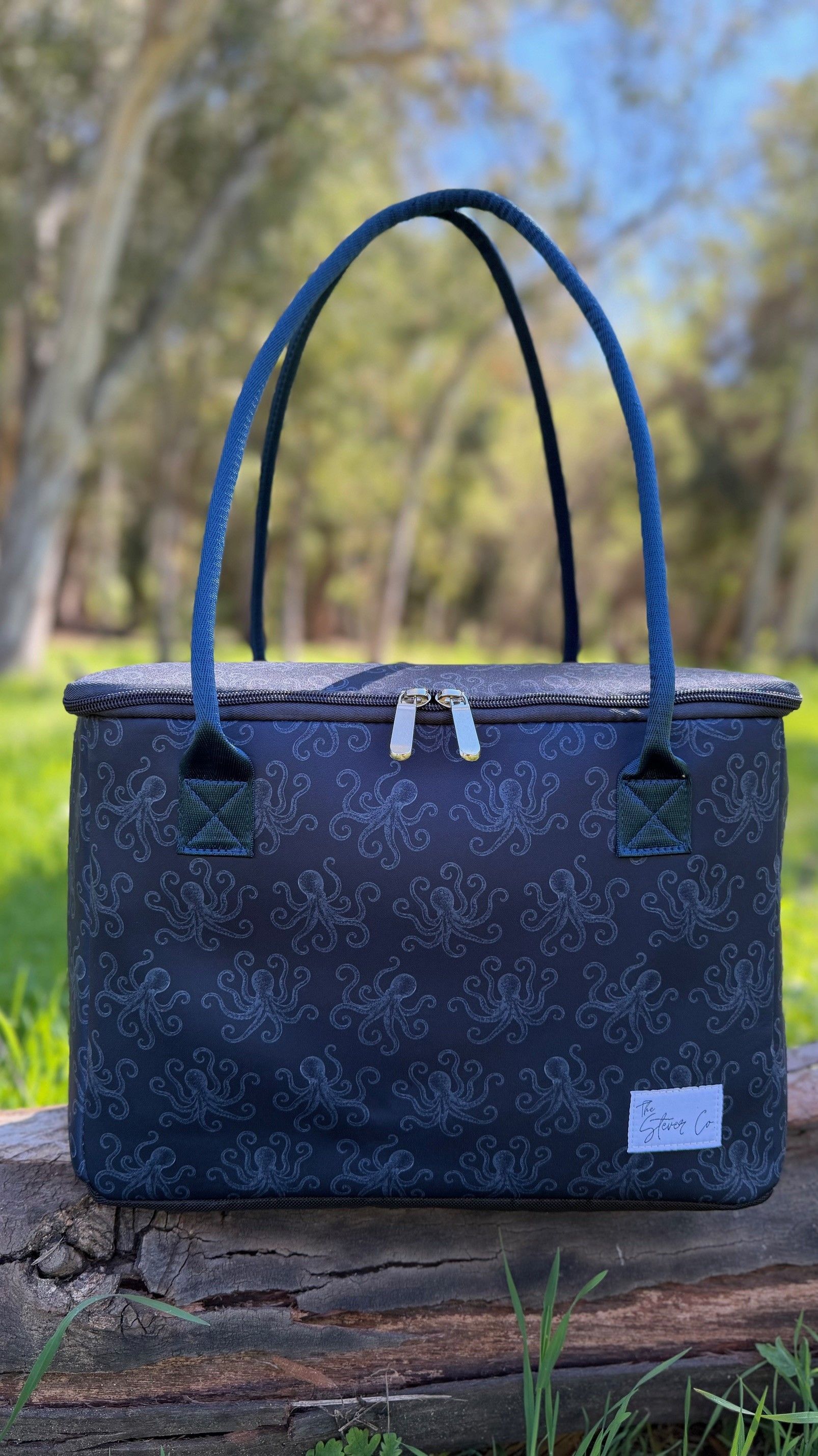 The Stever Co Tentacle Tide insulated tote with navy octopus pattern displayed outdoors