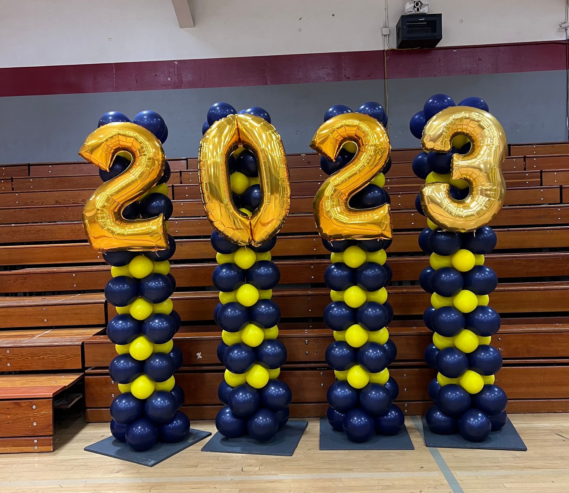 Four balloon columns spelling