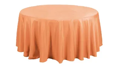 Round peach tablecloth draped over a table.