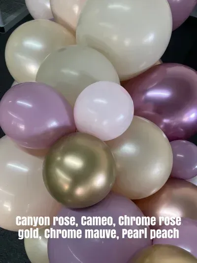 Balloons in shades of rose, mauve, peach, and gold.