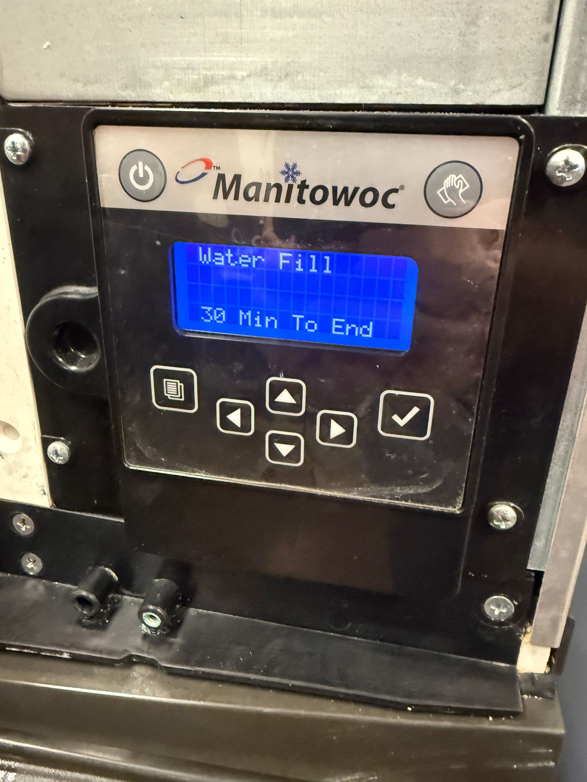 Blue-lit Manitowoc control panel display showing “Water Fill” and “30 Min To End” with arrow buttons.