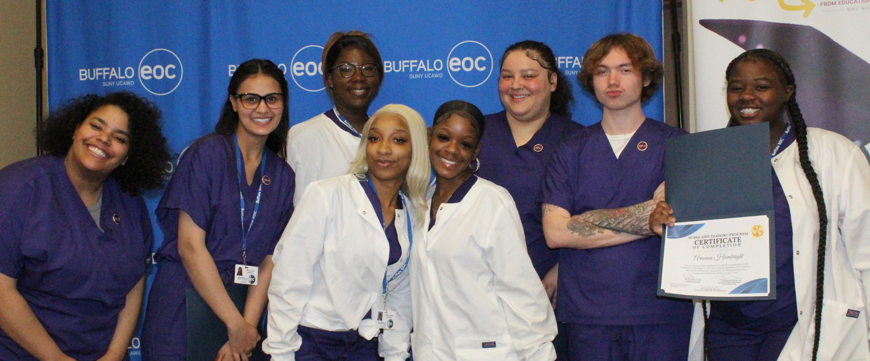 A group of nurses are posing for a picture while holding a certificate.