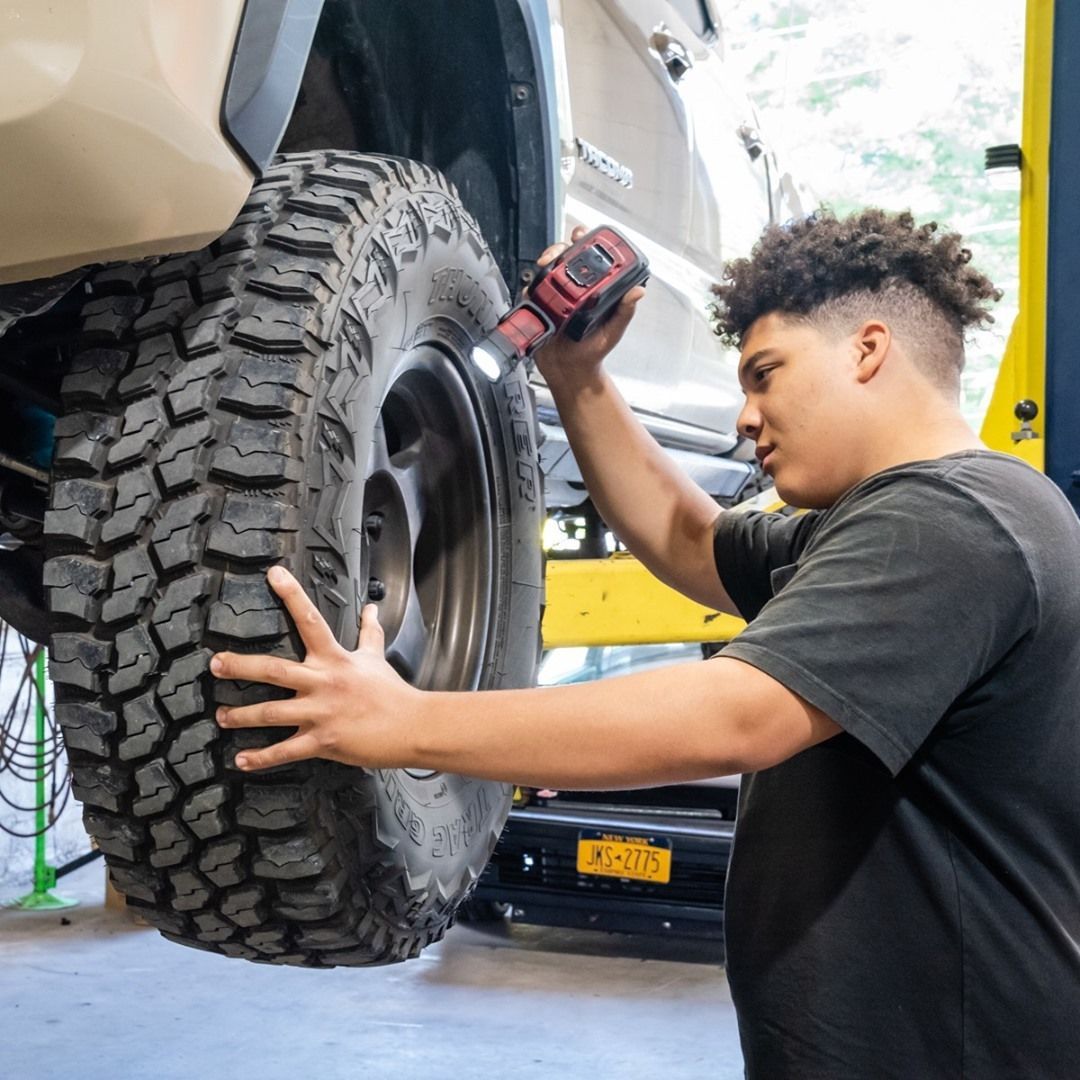 Mechanic working on Vehicle Tire | JCruz Motors