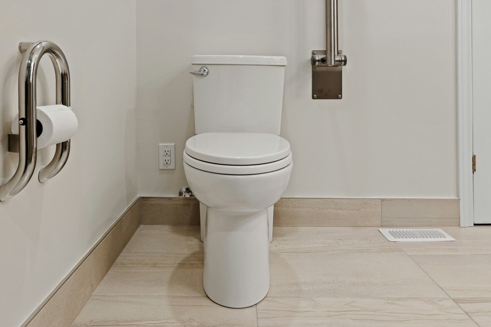 Accessible bathroom with toilet,, and open floor space designed during kitchen and bathroom remodeling in Avondale, AZ