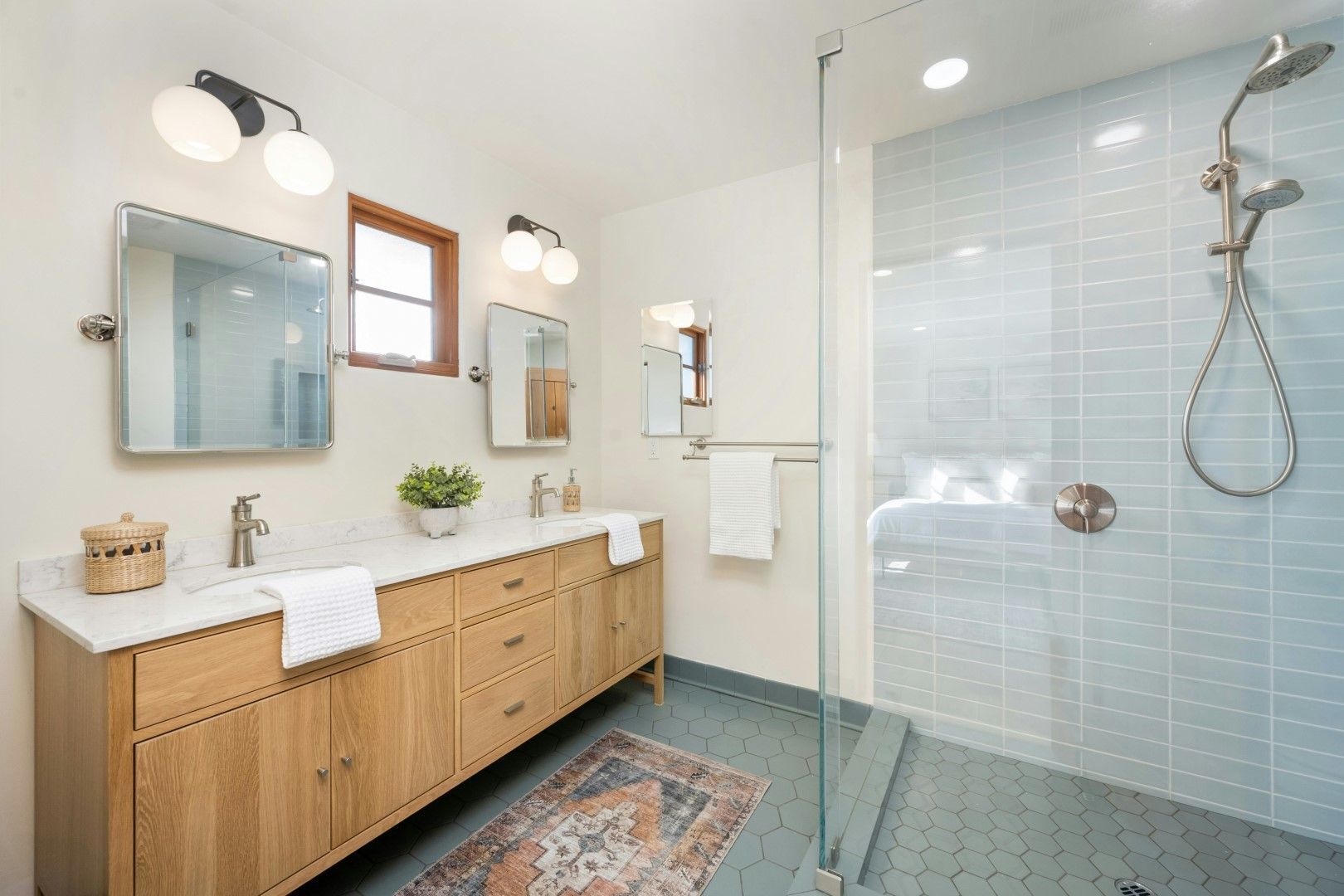 Bathroom with wood vanity, walk-in shower, and support features after kitchen and bathroom remodeling in Avondale, AZ