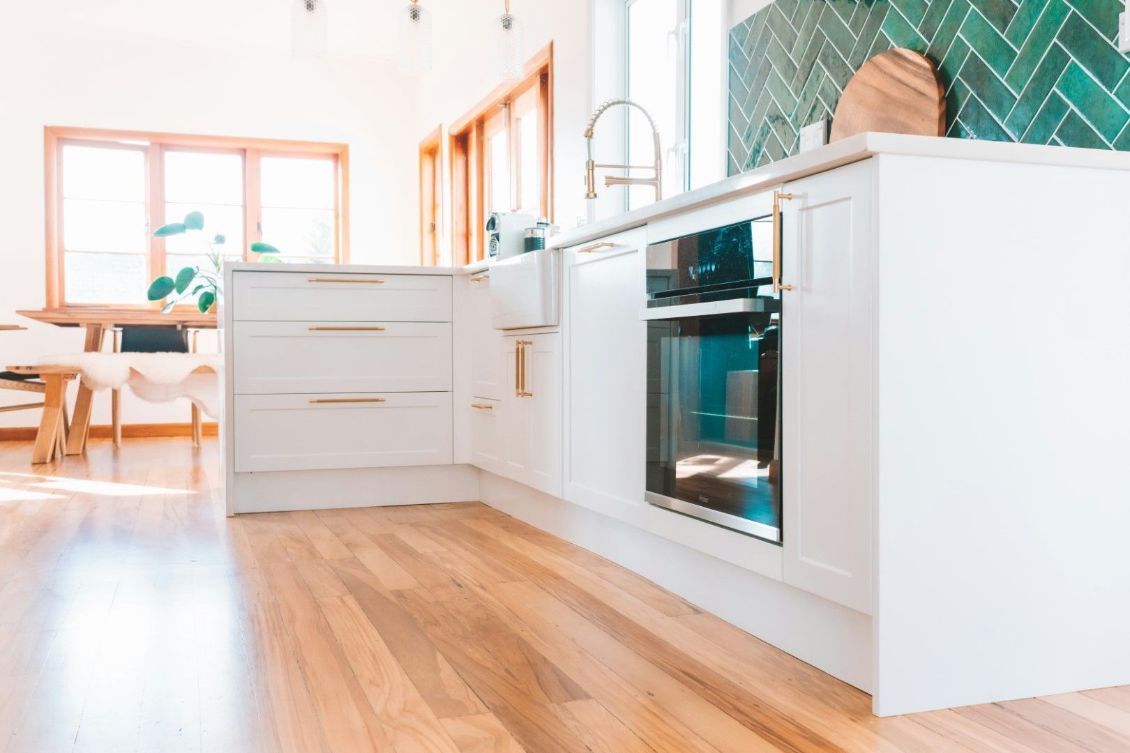 Bright white kitchen with clean flooring, built-in oven, and modern finishes after kitchen remodeling in Avondale, AZ