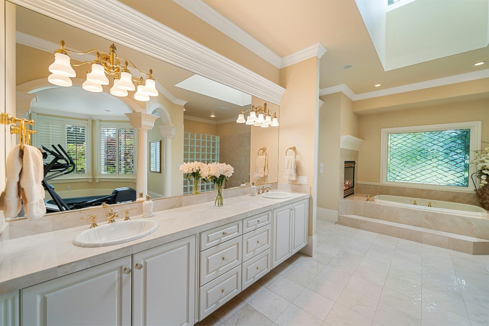 Luxury master bathroom with long vanity, soaking tub, and warm lighting after kitchen and bathroom remodeling in Avondale, AZ