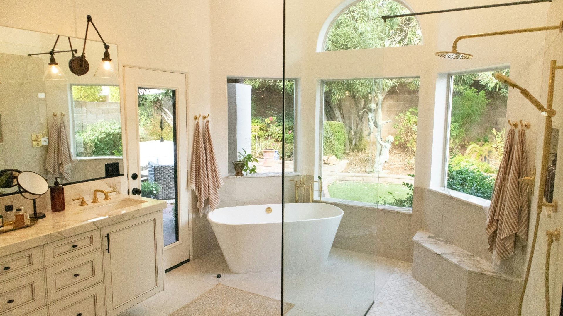 Master bathroom with freestanding tub, large windows, and vanity area after kitchen and bathroom remodeling in Avondale, AZ