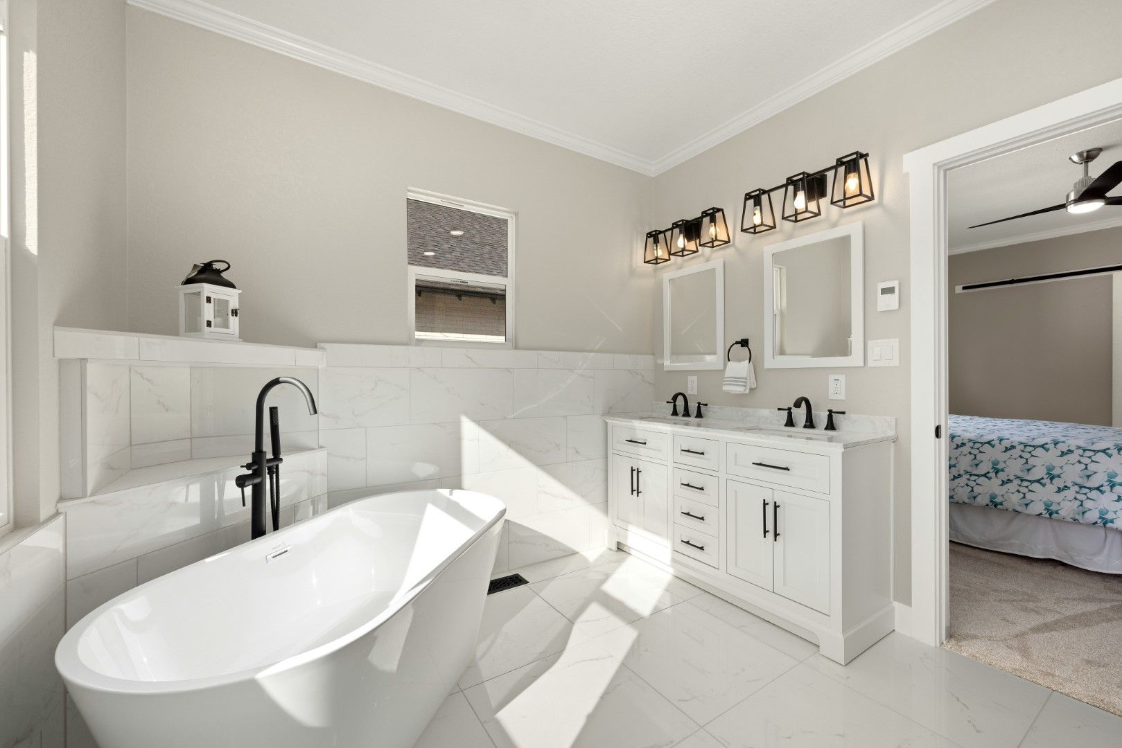 Master bathroom with freestanding tub, built-in cabinets, and bright finishes after bathroom remodeling in Avondale, AZ
