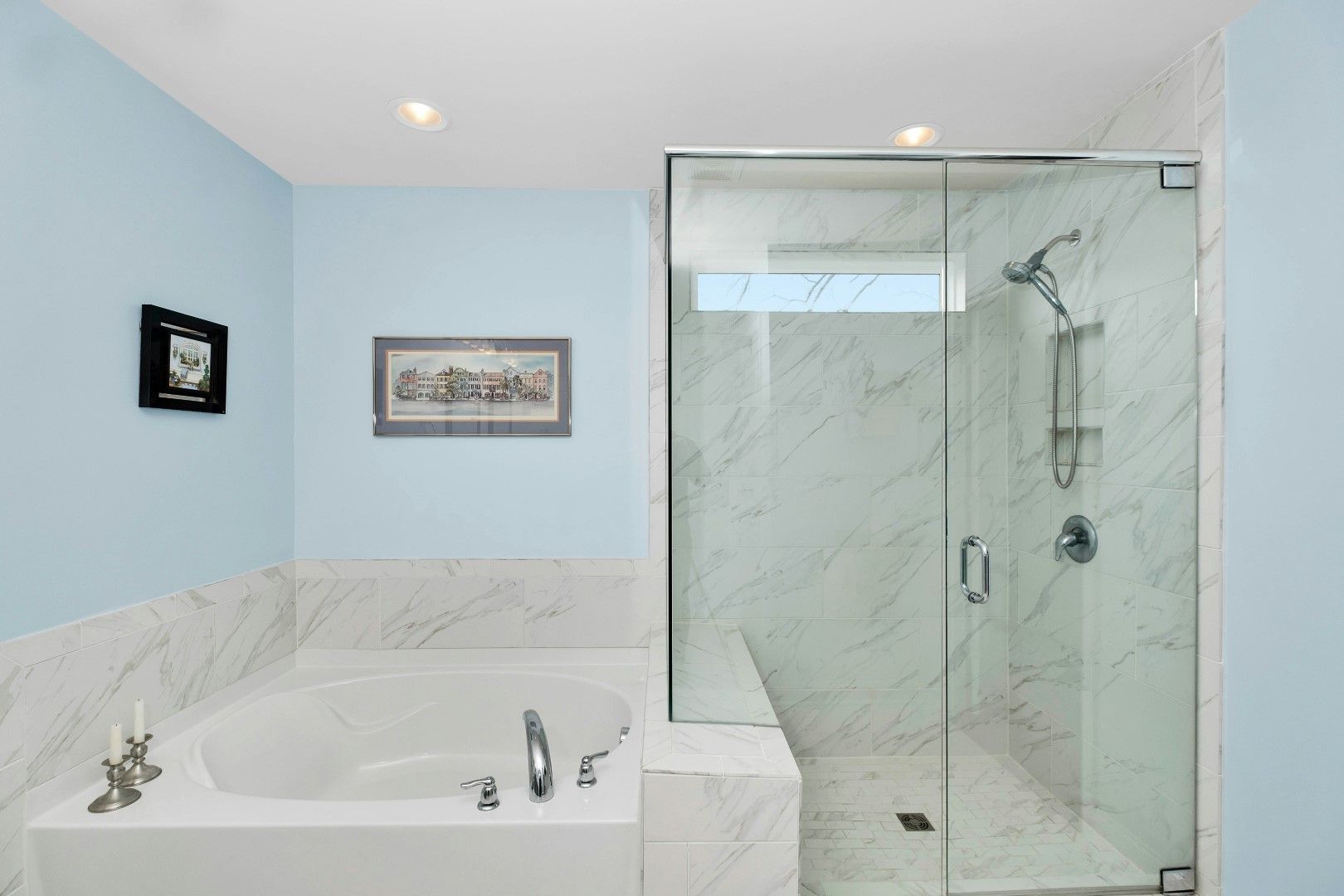 Bathroom with bathtub and glass shower enclosure after kitchen and bathroom remodeling in Avondale, AZ