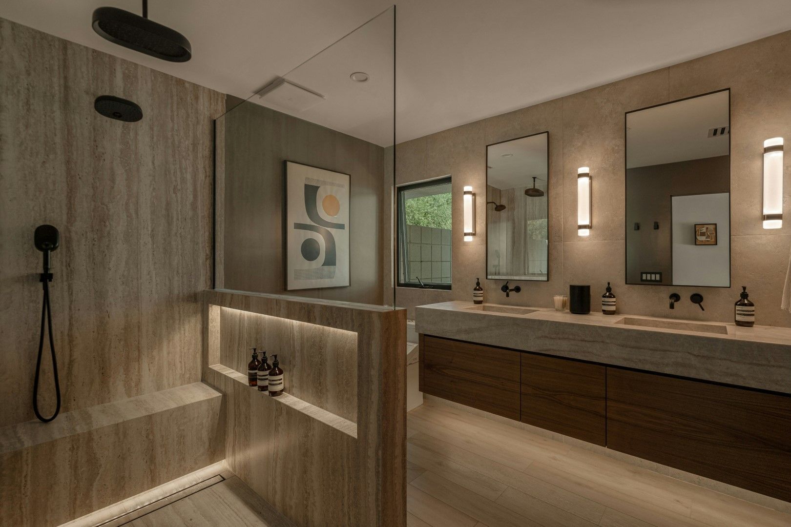 Modern walk-in shower with dark tile walls, built-in niche, and sleek fixtures after bathroom remodeling in Avondale, AZ