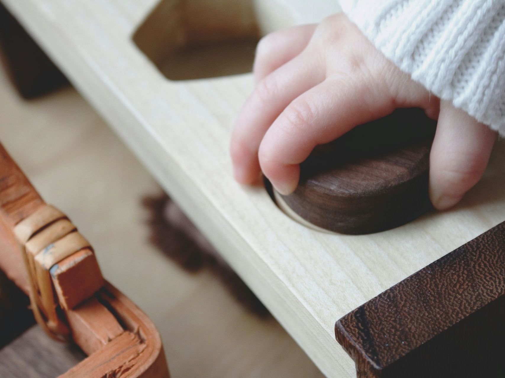 a child is playing with a wooden toy .