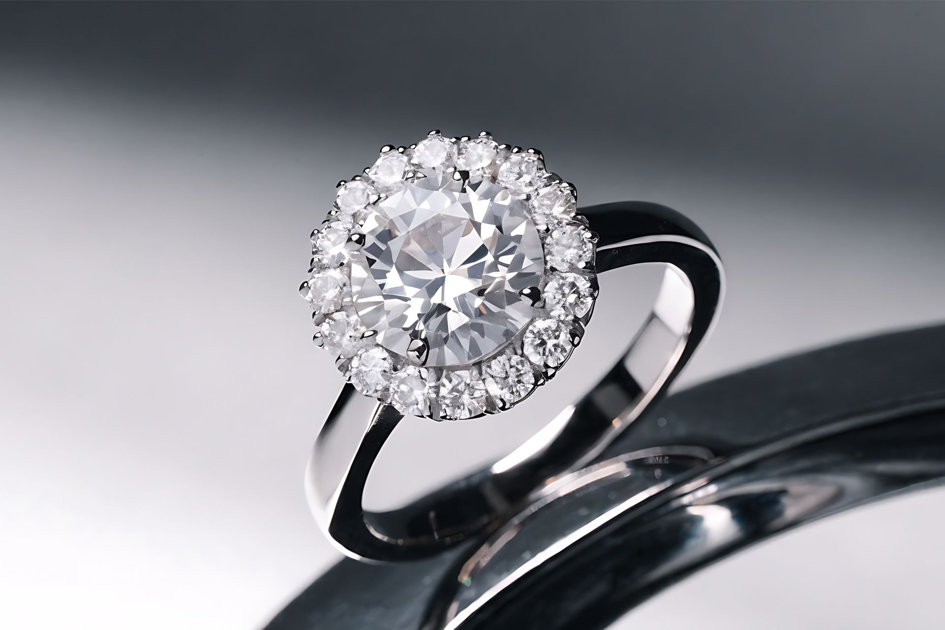 Diamond engagement ring with a halo setting on a reflective surface