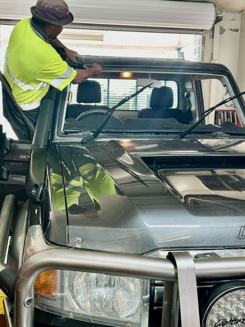 Worker Placing Window Car Tint — O'Brien Carglass & Tinting in Mareeba, QLD