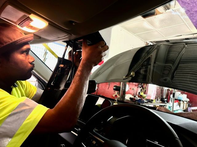 Man Changing a Side Window — O'Brien Carglass & Tinting in Mareeba, QLD