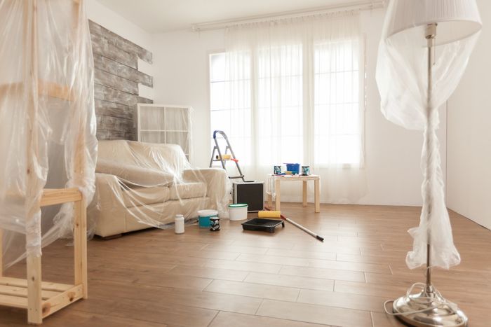 Living room  prepared for reno with drop sheets protecting the furniture