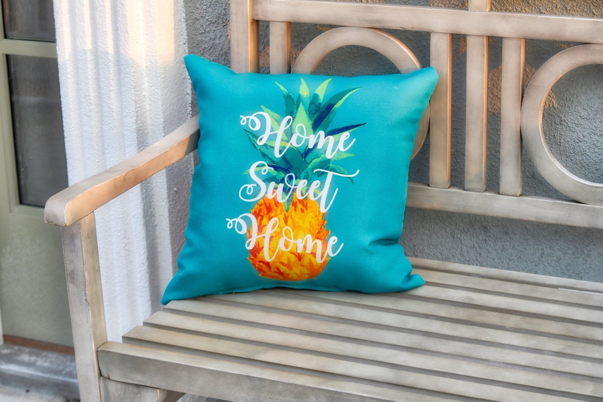 Wooden bench outside with a small pillow decoration