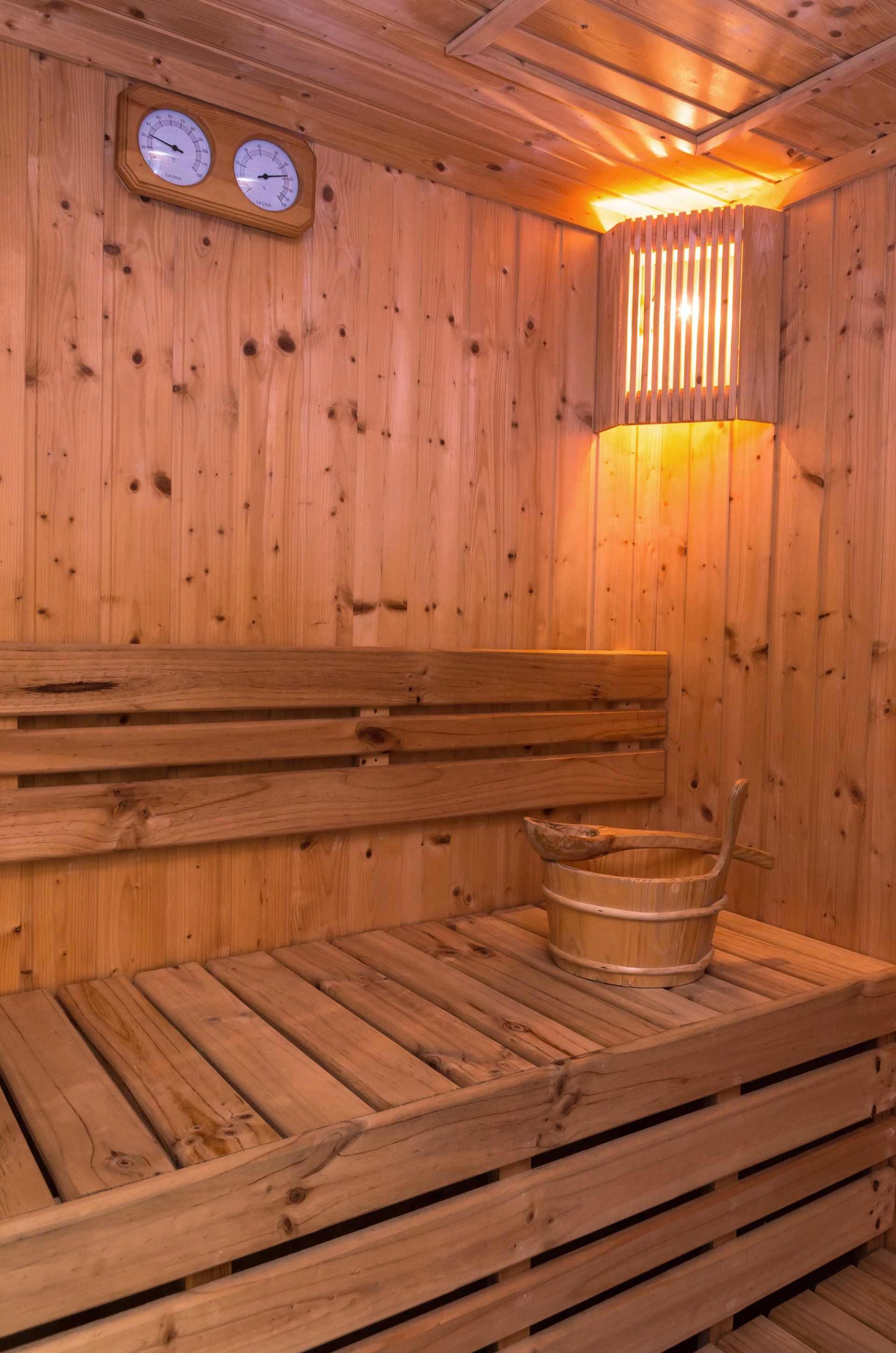 Sauna, steam room with wooden walls and temperature gauges on the wall