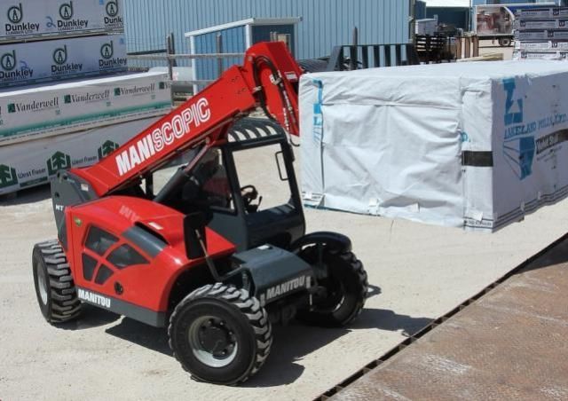 Manitou telehandler lifting materials at a construction site