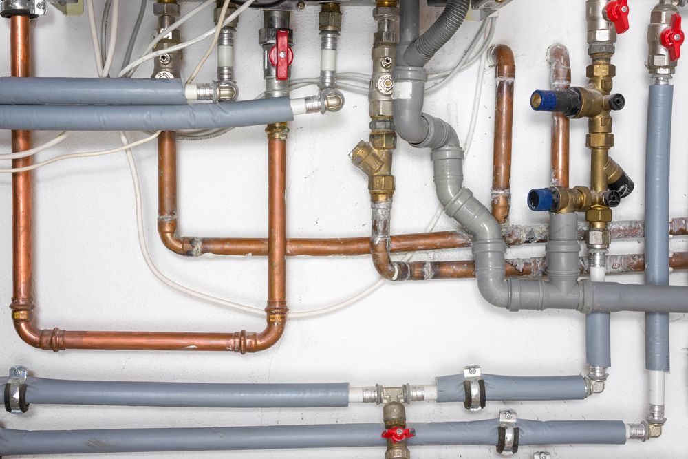A Bunch of Pipes Are Connected to Each Other on a Wall — Gastech Plumbing Services in Rural View, QLD