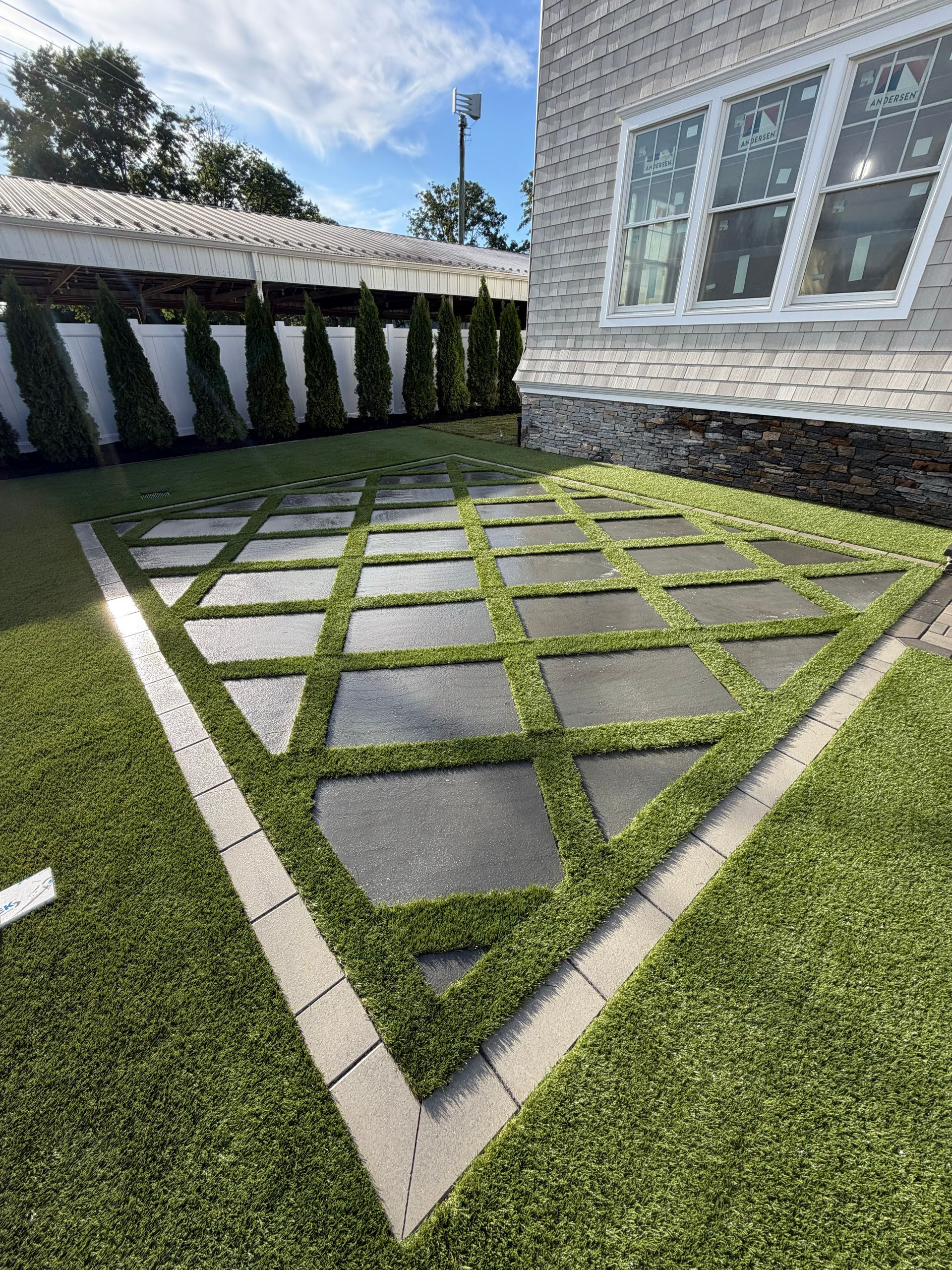 Artificial turf backyard with fenced landscape and deck