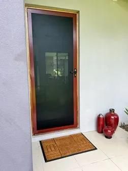 Exterior of a White House With a Decorative Security Door — All Security Screens & Repairs In Bungalow, QLD