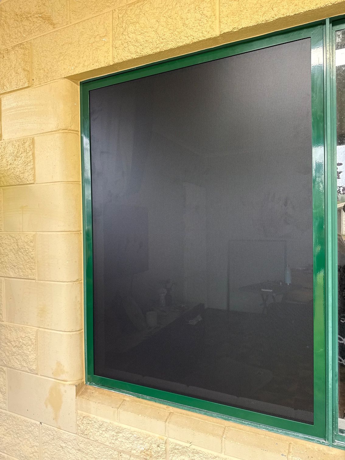 Black Screen Covering a Window, With a Green Frame — All Security Screens & Repairs In Bungalow, QLD