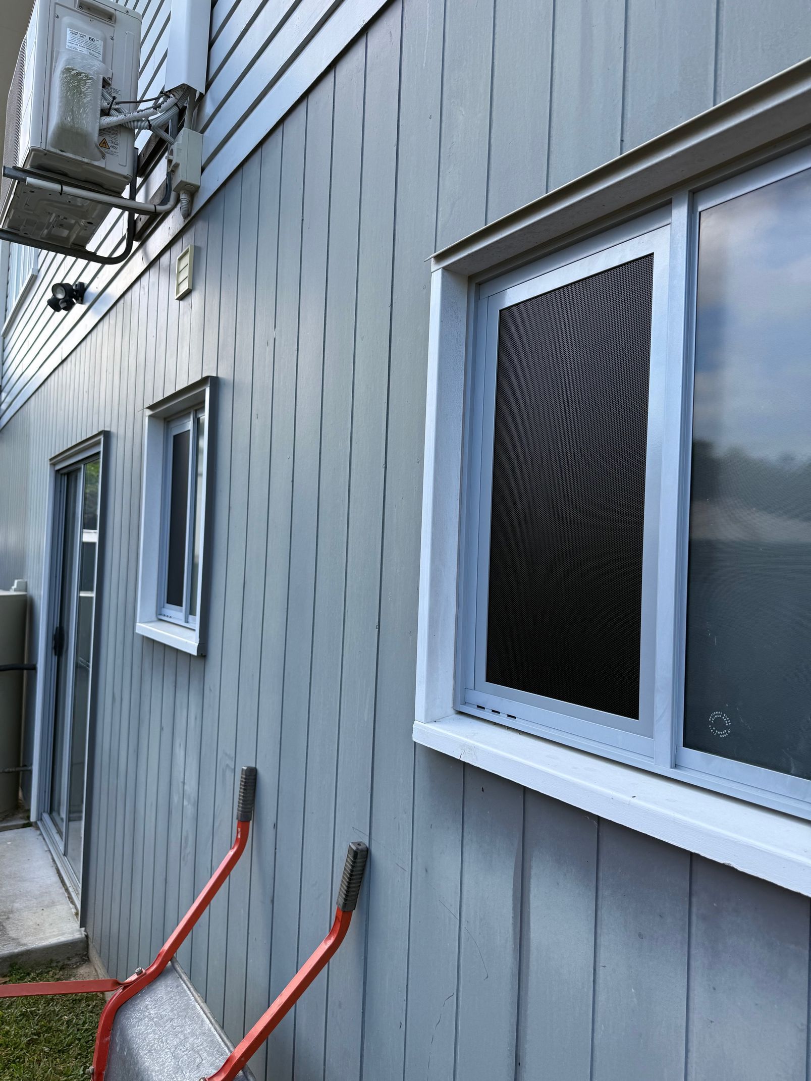 Exterior Wall With Siding, Windows, and an Air Conditioner Unit — All Security Screens & Repairs In Bungalow, QLD