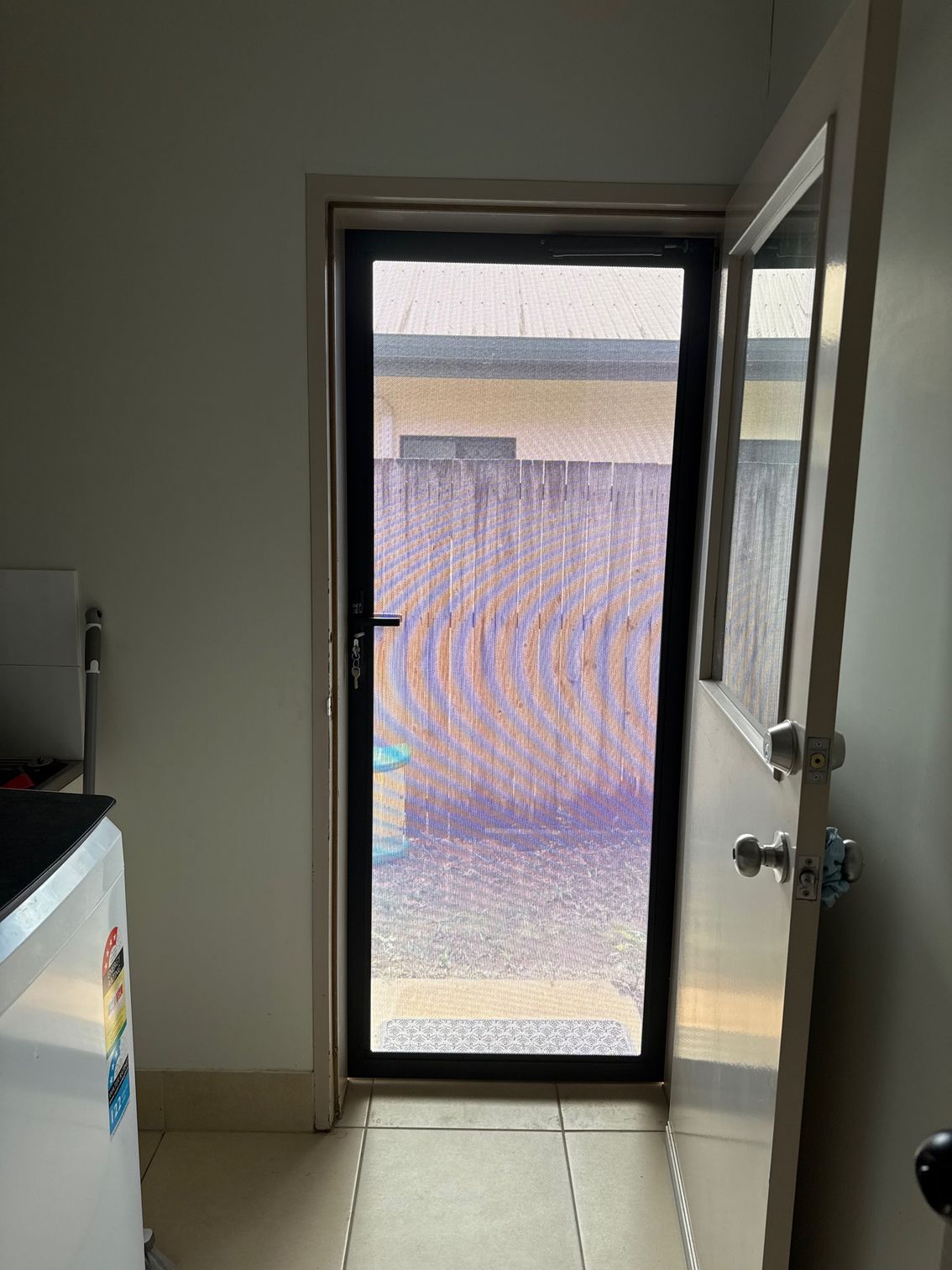 A Partially Open Screen Door Leads Outside — All Security Screens & Repairs In Bungalow, QLD