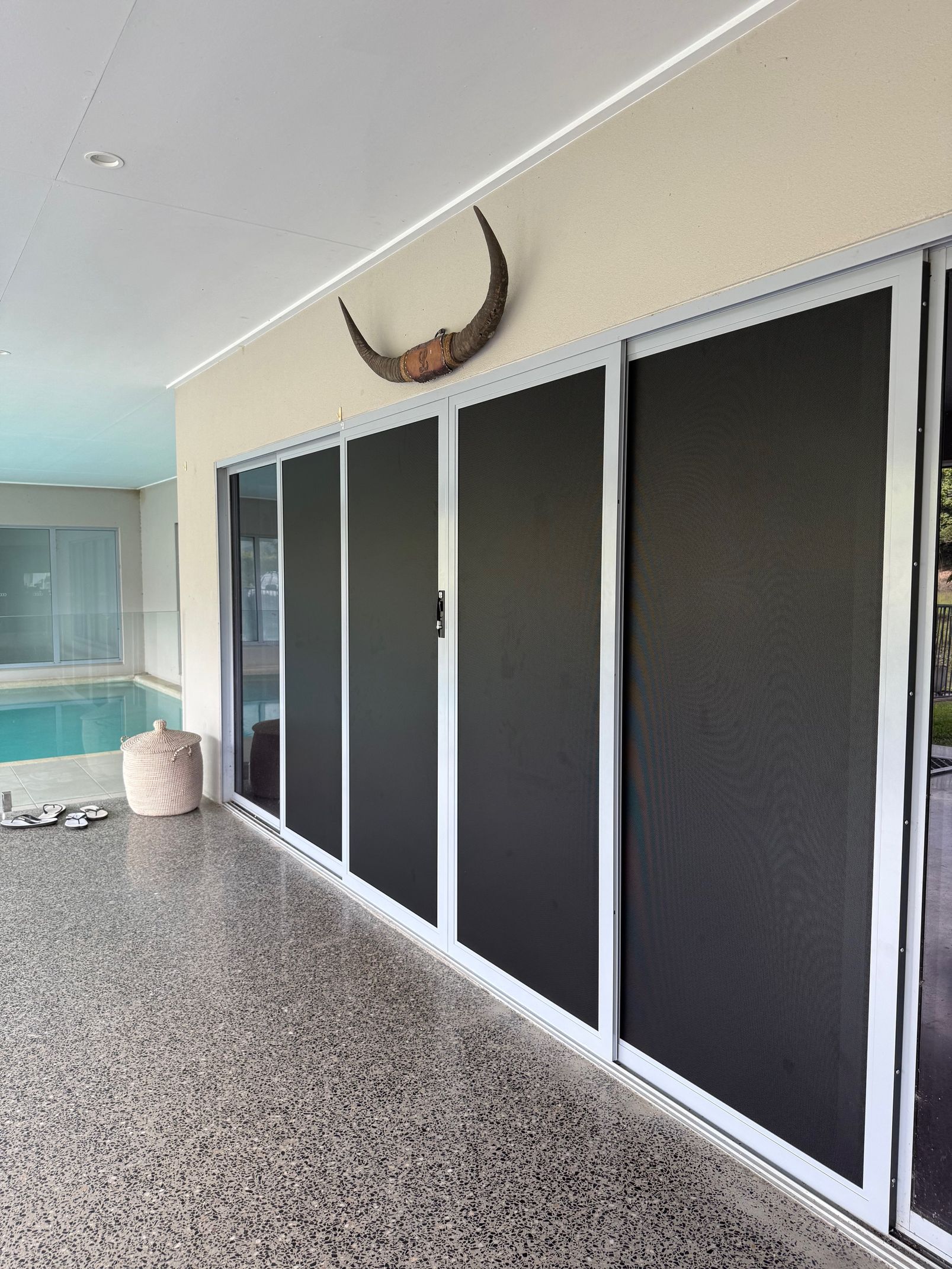 Sliding Glass Doors With Black Screens on a Patio — All Security Screens & Repairs In Bungalow, QLD