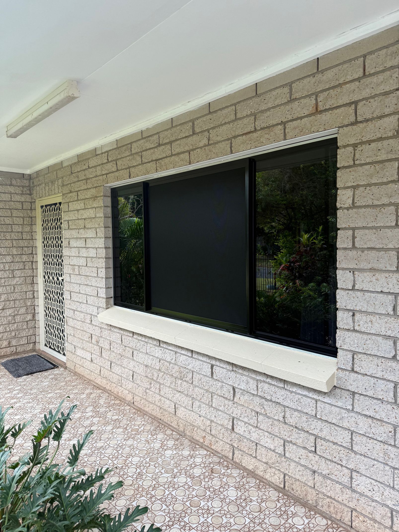 Exterior View of a Window on a Light Brick Wall — All Security Screens & Repairs In Bungalow, QLD