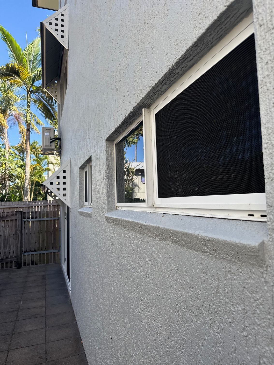 Exterior View of a Stucco Building — All Security Screens & Repairs In Bungalow, QLD