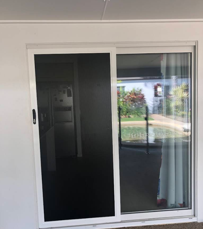 Hand Pulling a Recessed Door Handle on a Brown Sliding Door — All Security Screens & Repairs In Bungalow, QLD