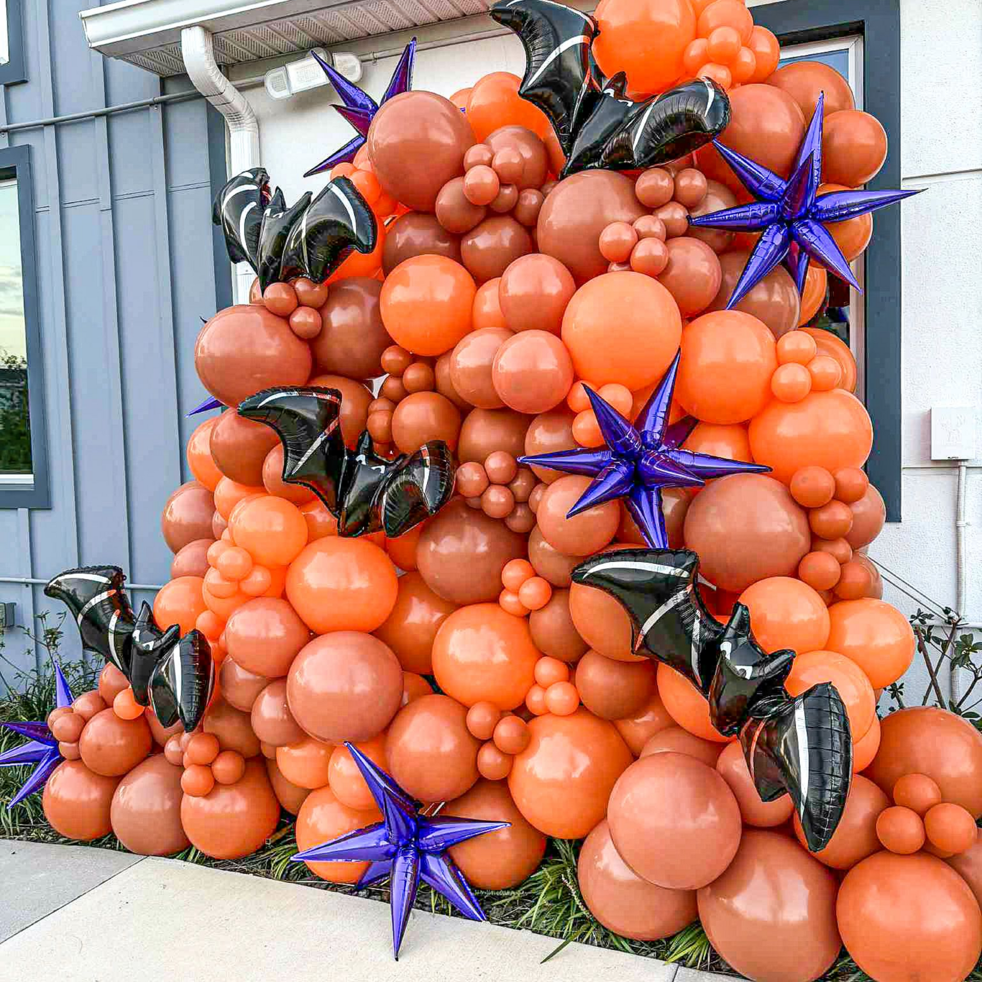 Orange Halloween balloon wall with black bats and spooky accents for a Central Florida event