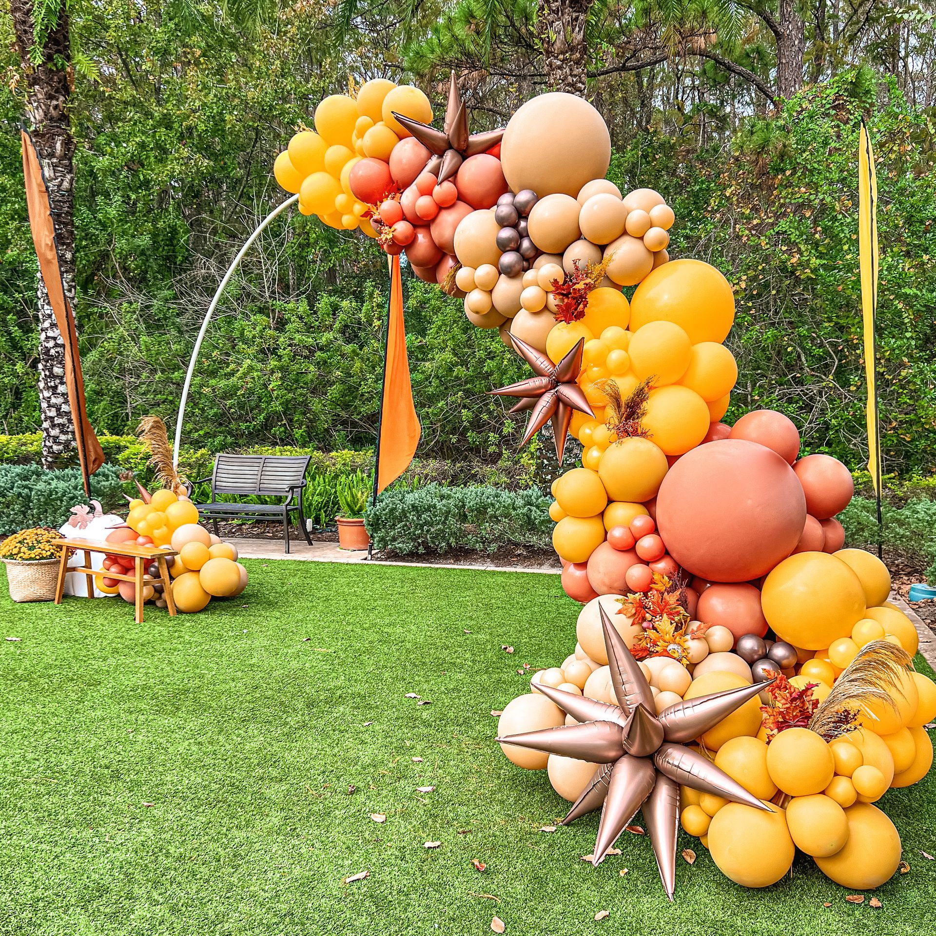 Autumn balloon arch with orange, gold and neutral balloons for a fall celebration in Orlando