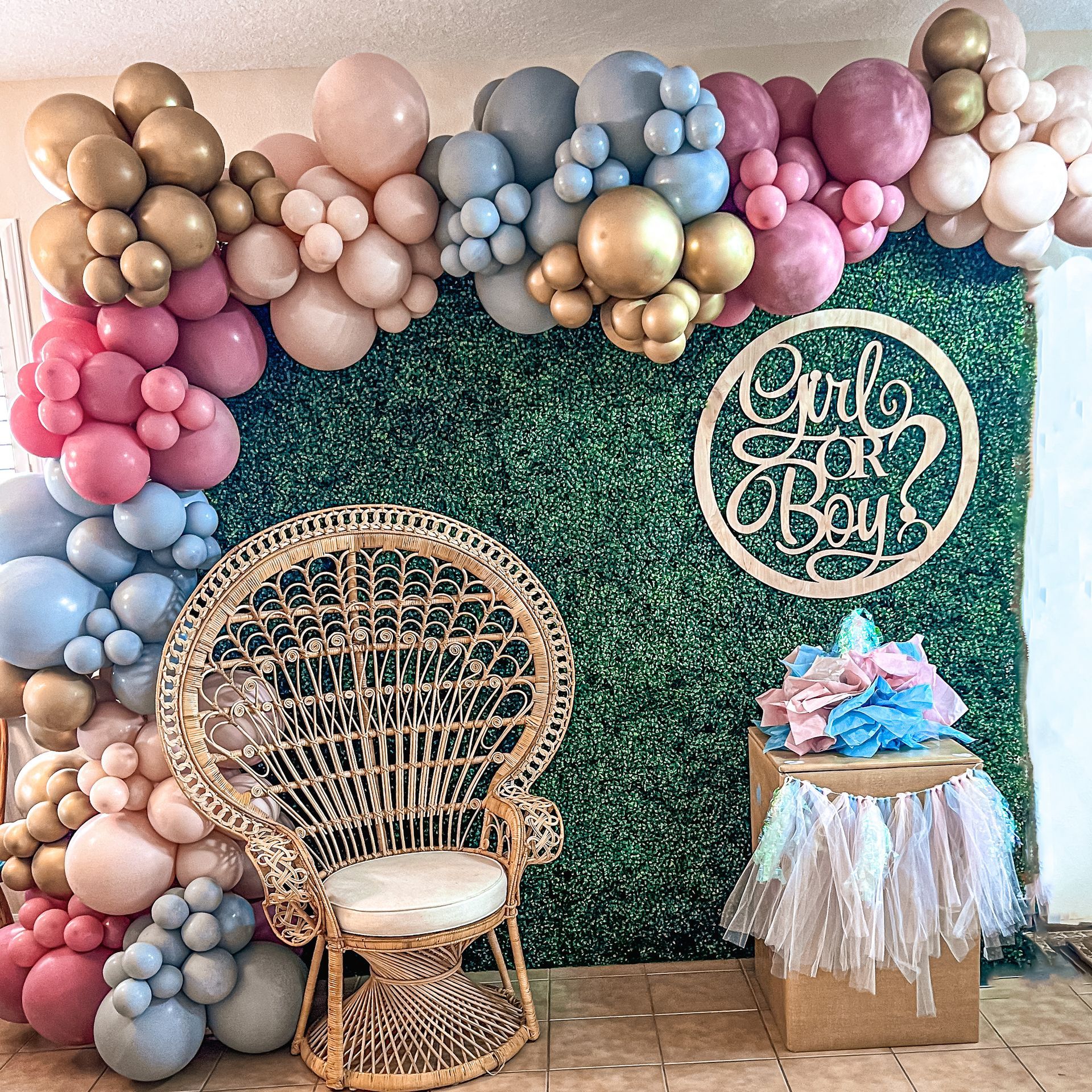 a wicker chair is sitting in front of a wall covered in balloons .
