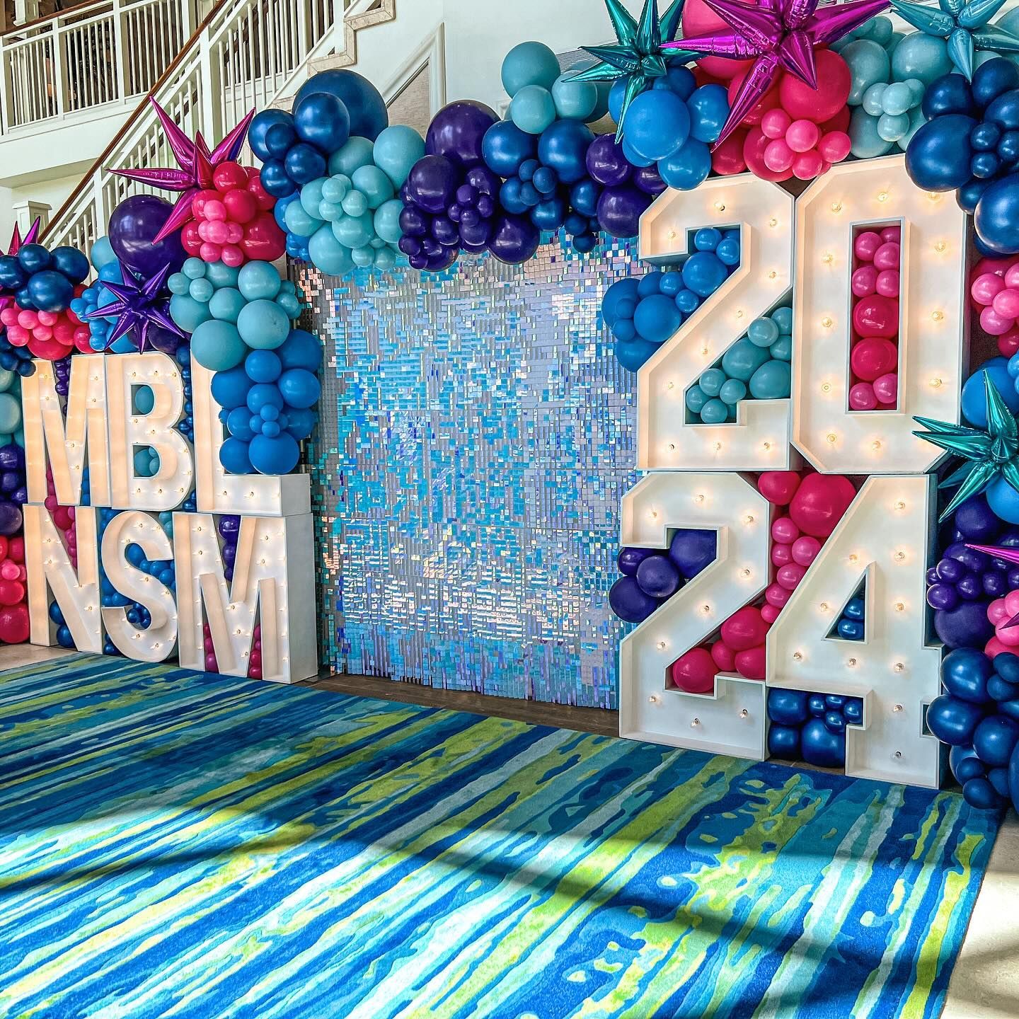 A room filled with balloons and a sign that says `` nsm ''.